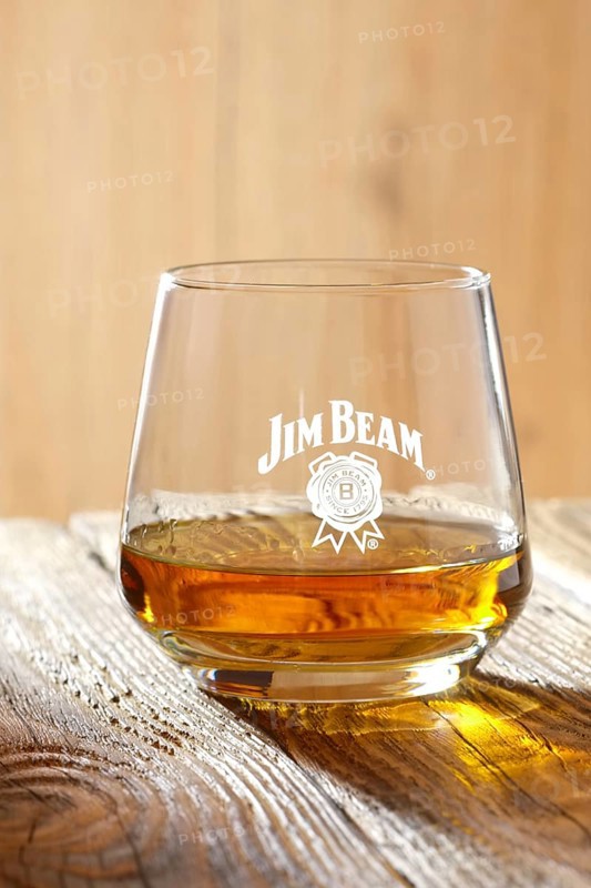 March 28, 2019, Minsk, Belarus, sniffer glass with kentucky straight bourbon whiskey on wooden table in sunlight, Europe