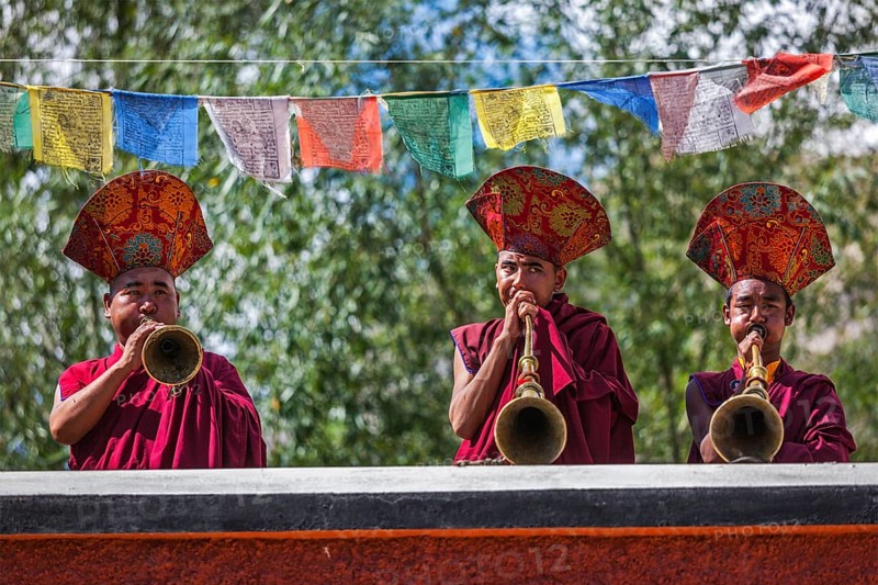 HUNDER, INDIA, SEPTEMBER 6, 2011: Tibetan Buddhist monks playing traditional musical instruments. Hunder, Nubra valley, Ladakh, India, Asia
