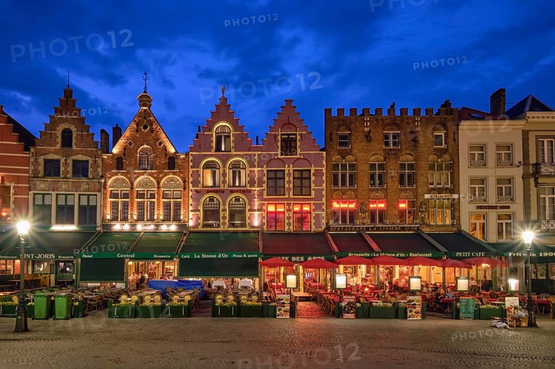 Bruges, Belgium, May 29, 2018: Bruges Grote markt square famous tourist place with many cafe and restaurants in the evening night twilight, Europe