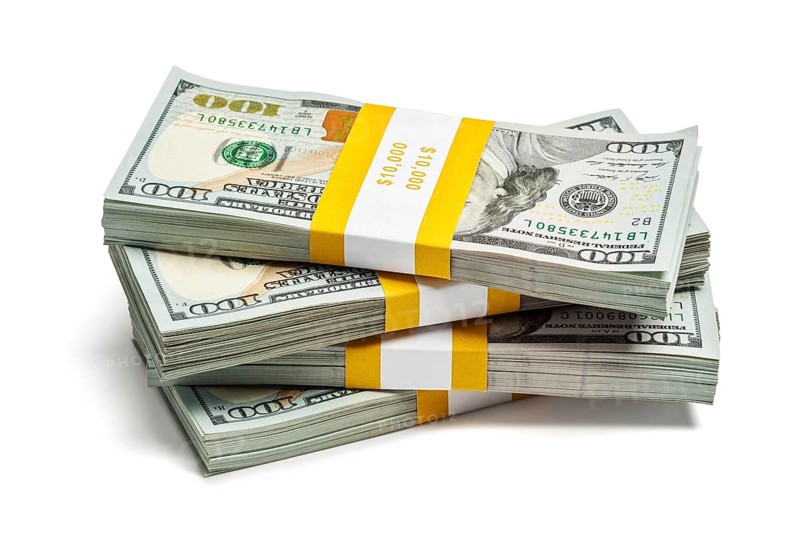 Creative business finance making money concept, stack of bundles of 100 US dollars 2013 edition banknotes bills isolated on white
