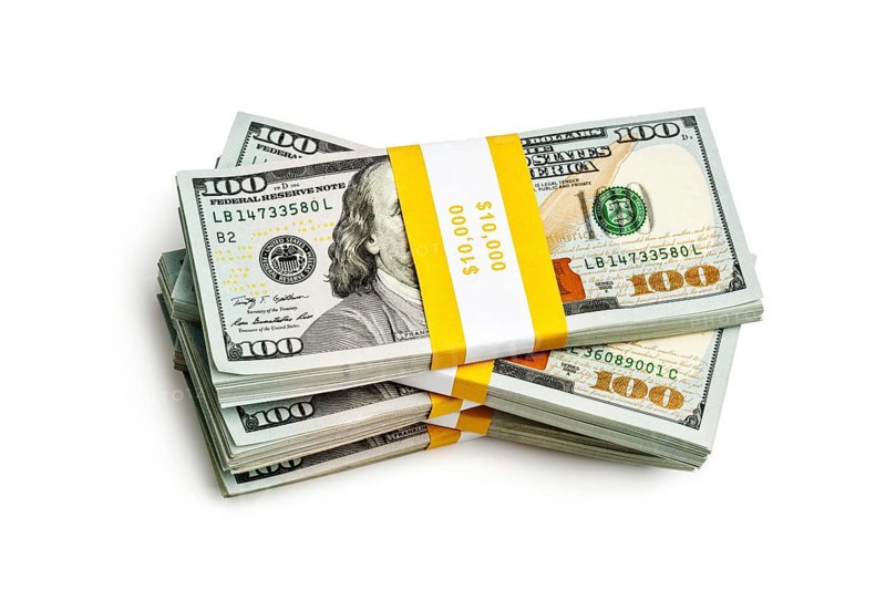 Creative business finance making money concept, stack of bundles of 100 US dollars 2013 edition banknotes bills isolated on white