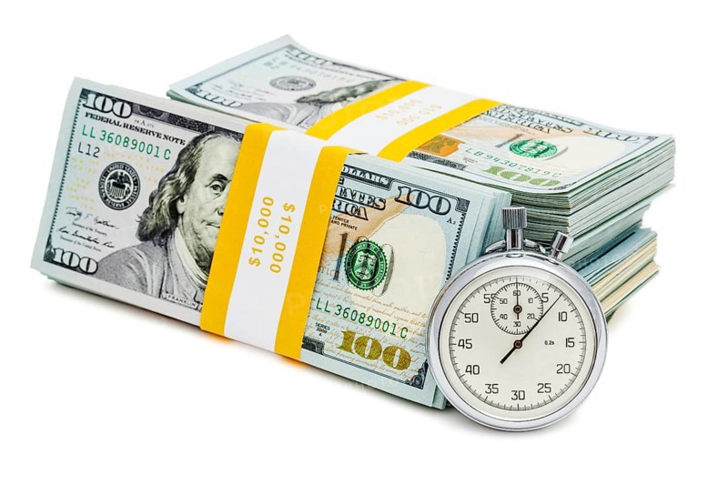 Time is money loan concept background, stopwatch and stack of new 100 US dollars 2013 edition banknotes bills bundles isolated on white