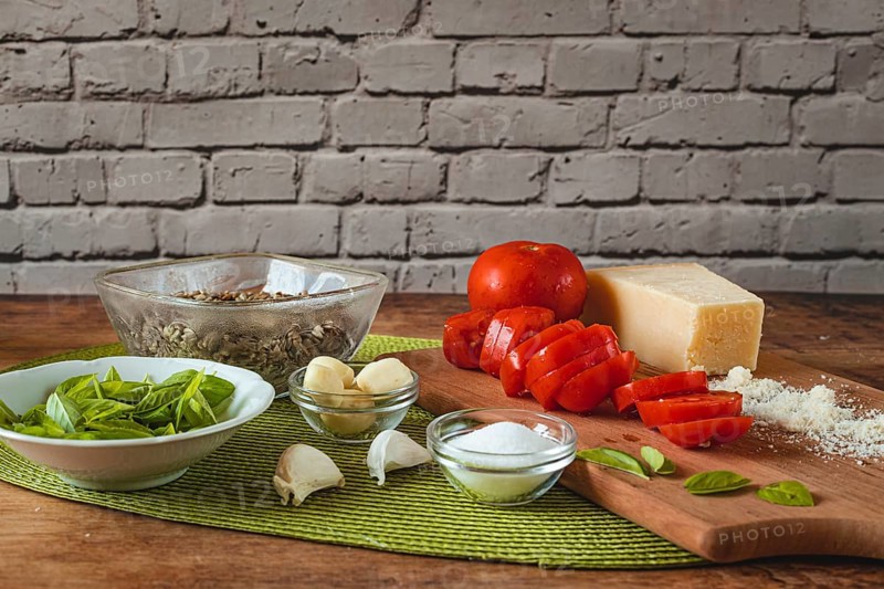 Food photography, making tomato pesto, with tomatoes (Solanum lycopersicum), salt, sunflower (Helianthus annuus) seeds, sunflower oil, basil (Ocimum basilicum), Parmesan cheese, garlic (Allium sativum)