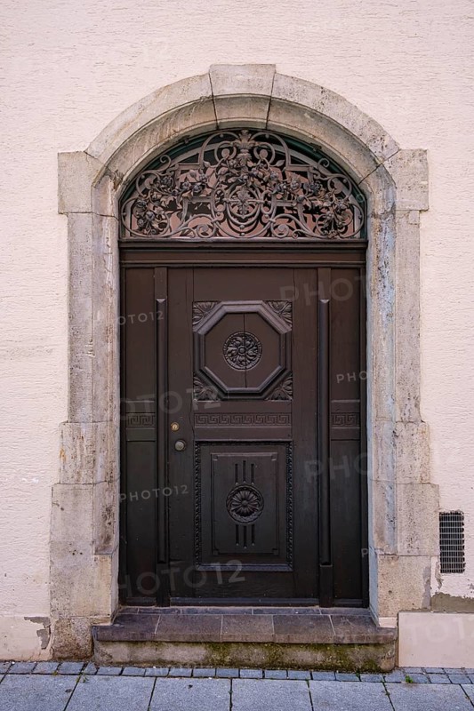 Artfully crafted round-arched door in a historic building on Manghausplatz in the old town of Memmingen in Unterallgäu, Swabia, Bavaria, Germany, Europe