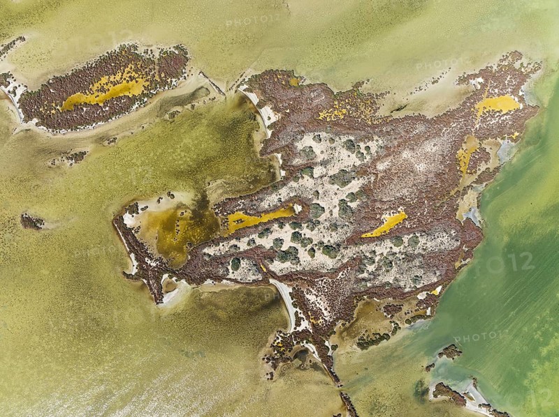 Islands and conspicuous patterns at the shallow lagoon Salinas de Cerrillos, aerial view, drone shot, Almería province, Andalusia, Spain, Europe