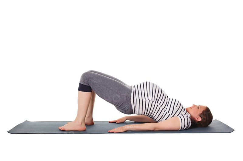 Pregnancy yoga exercise, pregnant woman doing yoga asana Purvottanasana Upward Plank Pose isolated on white background