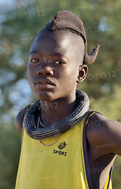 Young Himba boy wearing a traditional headdress, Omohanja, Kaokoland, Kunene, Namibia, Africa