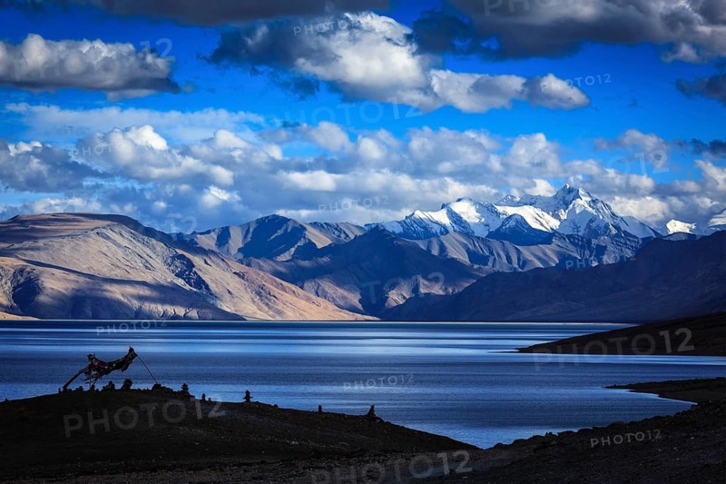 Buddhist prayer flags lungta at Himalayan lake Tso Moriri on sunset, Korzok, Ladakh, India, Asia