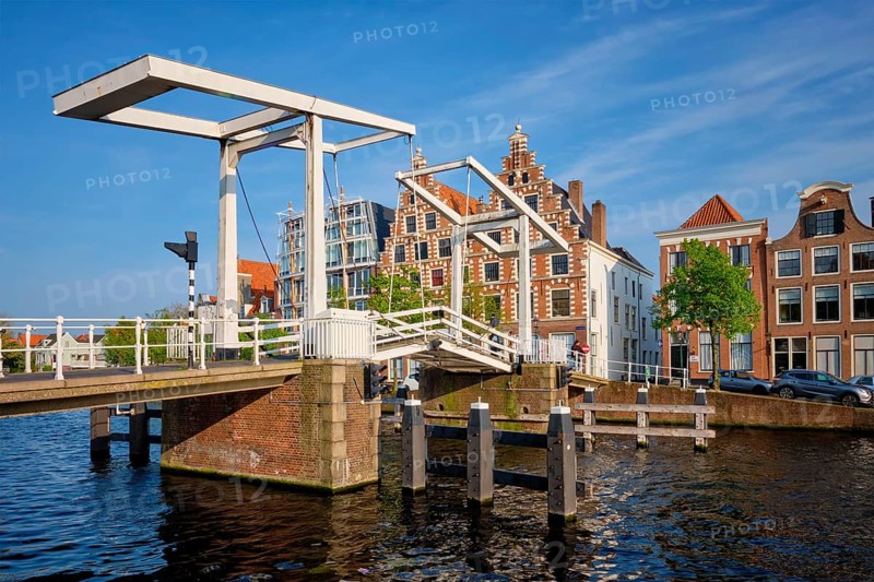 Gravestenenbrug bridge on Spaarne river and old houses in Haarlem, Netherlands