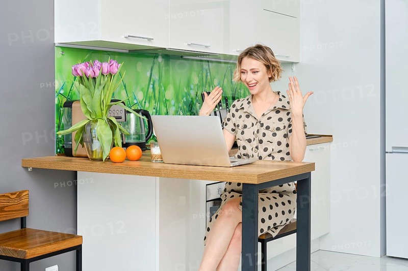 Woman communicates online using video messenger or making internet call while being at home