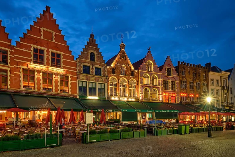 Bruges, Belgium, May 29, 2018: Bruges Grote markt square famous tourist place with many cafe and restaurants in the evening night twilight, Europe