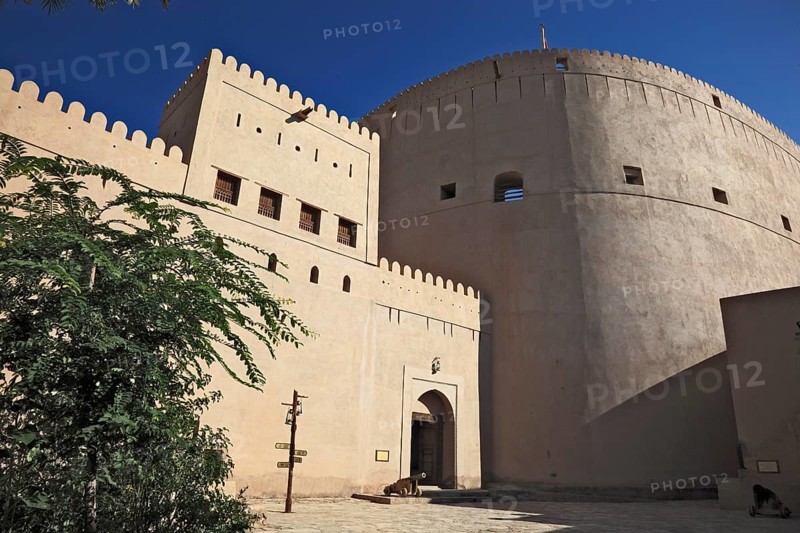 Entrance and fortification at Nizwa Fort. Nizwa is the centre of the Omani heartland. The oasis city lies on the southern edge of the Hajar Mountains near the Jabal al-Achdar, Oman's highest mountain range