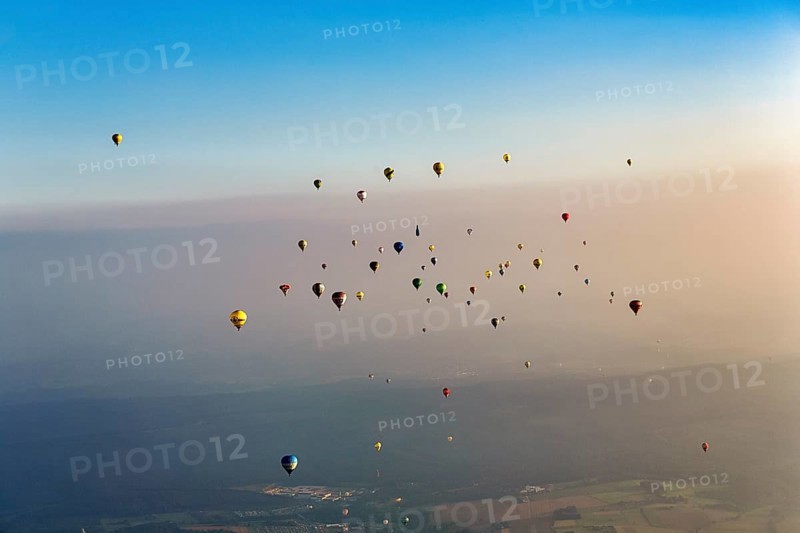 Many different hot air balloons on the way in the blue sky, distance, hot air balloon festival, 26th Warsteiner International Montgolfiade, evening haze, aerial view, Warstein, Sauerland, North Rhine-Westphalia, Germany, Europe