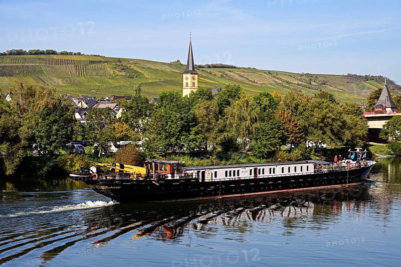 Barge travelling on the Moselle past the village of Trittenheim, Rhineland-Palatinate