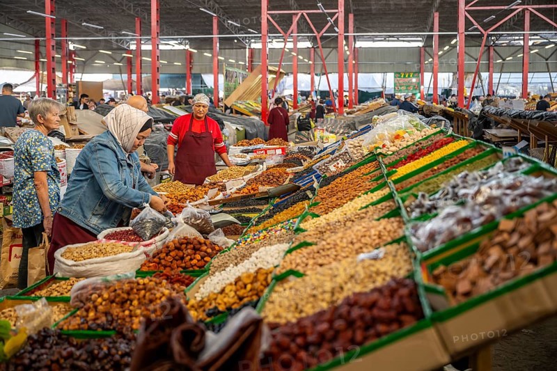 Traditional woman selling food, market stall at Osh Bazaar, Bishkek, Kyrgyzstan, Asia
