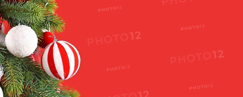 Christmas banner with striped red and white bauble on tree branch