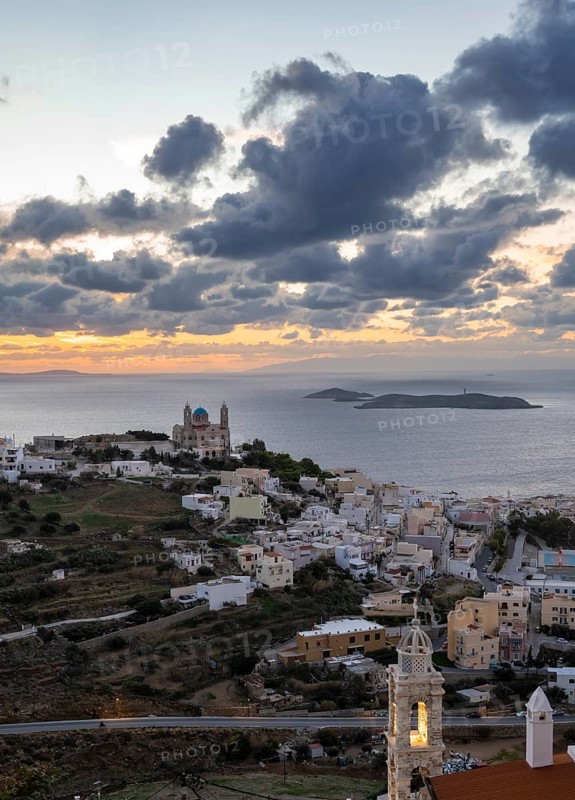 View from Ano Syros to the houses of Ermoupoli with the Anastasi Church or Church of the Resurrection, town view with islands and sea, dramatic cloudy sky at sunrise, Ano Syros, Syros, Cyclades, Greecev