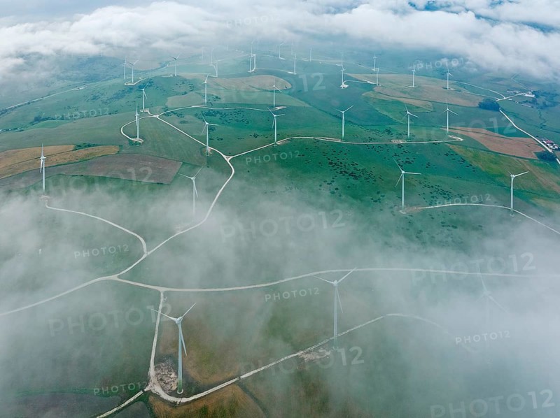 Windmills on a wind farm near Zahara de los Atunes, at a cloudy morning, aerial view, drone shot, Cádiz province, Andalusia, Spain, Europe