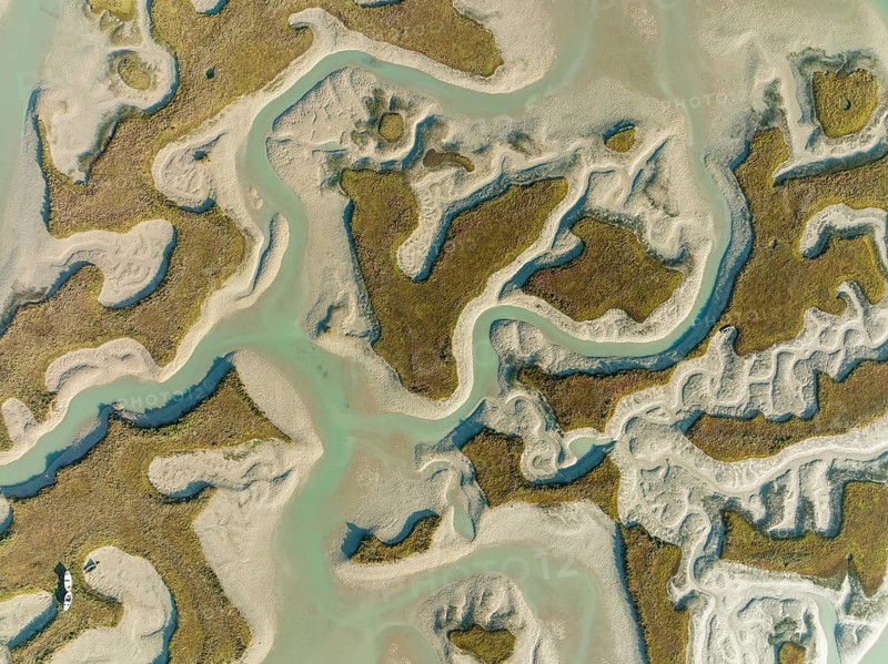 Network of channels and streams at low tide, in the marshland of the Bahía de Cádiz, aerial view, drone shot, Cádiz province, Andalusia, Spain, Europe