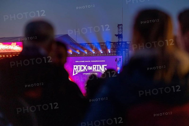 Adenau, Germany, 7 June 2024: Fans enjoy the Rock am Ring Festival during the blue hour. The festival takes place at the Nürburgring race track near the town of Adenau from 7 to 9 June 2024, Europe