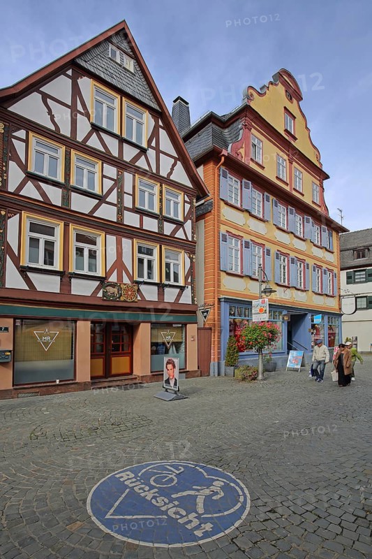 Baroque Joutz's house built in 1695 with tail gable and traffic sign on the ground with symbol cyclist and pedestrian inscription, consideration, respect, tolerance, attention, observe, heart-shaped, blue, white, pedestrian zone, Butzbach, Wetterau, Hesse, Germany, Europe