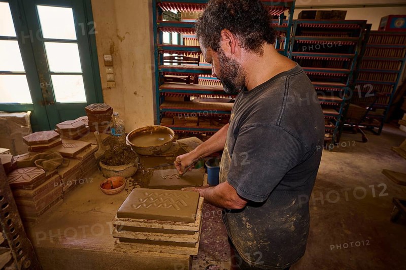 Man moulding clay bricks in a traditional pottery workshop with natural light, Brickworks Patmos Cotto, Traditional brick making, Kampos, Patmos, Dodecanese, Greek Islands, Greece, Europe