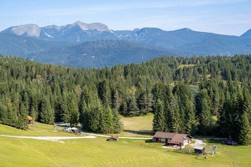 Landscape and buildings at Kranzberg, behind Karwendel Mountains, Mittenwald, Werdenfelser Land, Upper Bavaria, Bavaria, Germany, Europe