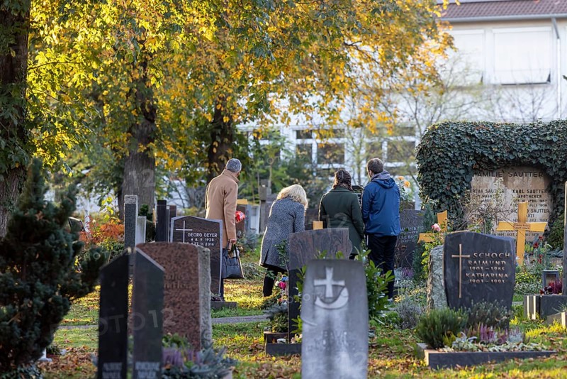 All Saints' Day at the Bergfriedhof cemetery in Stuttgart. Catholics commemorate their deceased relatives. Grave decorations and candles. Stuttgart, Baden-Württemberg, Germany, Europe