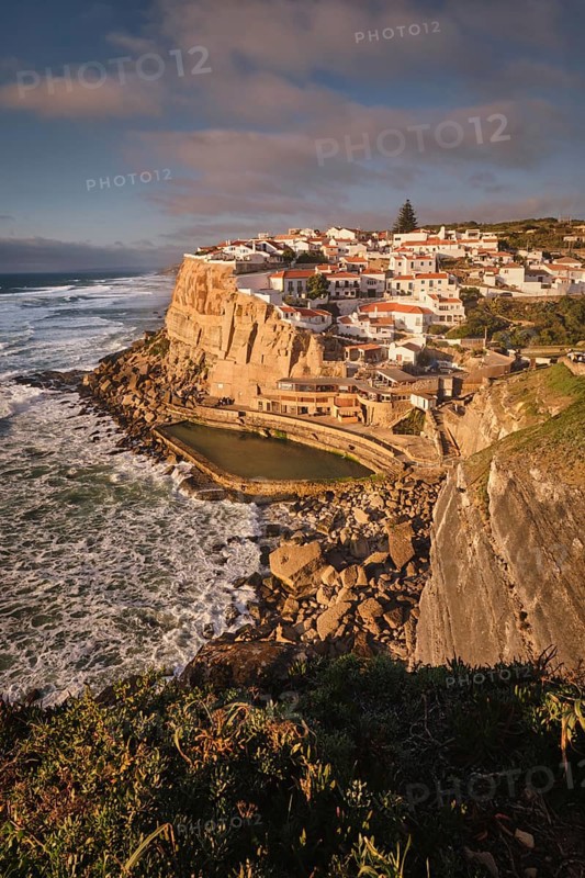 Scenic view of the seaside Azenhas do Mar fishing village on cliff on Atlantic ocean coast, Portugal on sunset