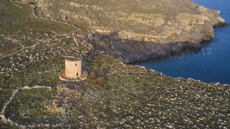 Drone shot, Lindos, late afternoon light, drone view of an old windmill on a rocky shore in the golden light of dusk, Archaeological site, Lindos, Rhodes, Dodecanese, Greek Islands, Greece, Europe