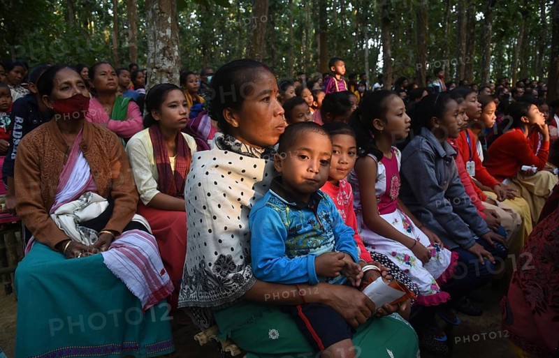 People enjoying a drama during 'Under The Sal Tree' Theatre Festival on December 15, 2021 in Goalpara, Assam, India. Under the Sal Tree theatre festival is one of its kind, held at Badungduppa Kala Kendra in the middle of a dense Sal forest in rural Lower Assam. The festival was started by Sukracharjya Rabha, a widely respected theatre personality of Assam, in 2008. He wanted to spread a message of coexistence with nature and made in a completely natural setting inside a jungle, which made the theatre festival unique