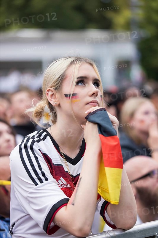 A woman watches the football match in the fan zone at the Brandenburg Tor during the quarter-final match between Germany and Spain at the European Football Championship, Berlin, 05/07/2024
