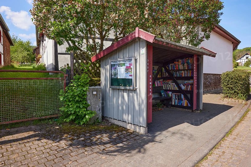 Book exchange station and notice board for official announcements in the district of Pesch, Nettersheim, Eifel, Euskirchen district, North Rhine-Westphalia, Germany, Europe
