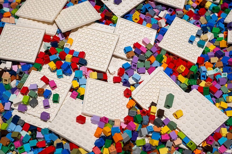 Different coloured Lego bricks and building boards chaotically distributed, Copenhagen, Denmark, Europe