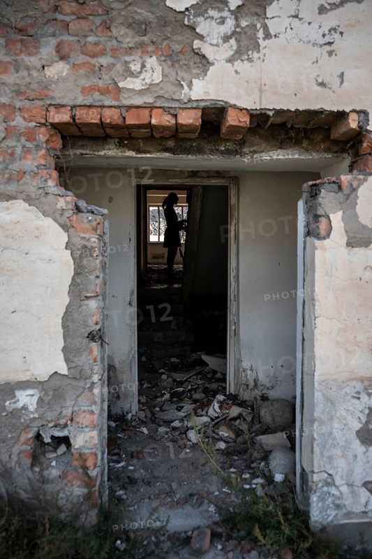 Entrance to an abandoned ruined residential building, old Soviet apartment blocks in the ghost town, Engilchek, Tian Shan, Kyrgyzstan, Asia