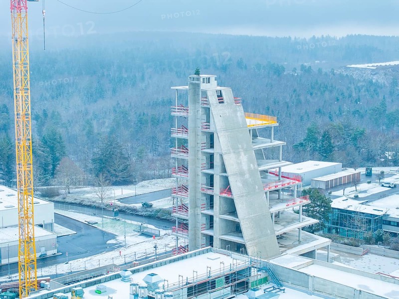 Unfinished building in winter with crane and snow-covered surroundings, Nagold, Häfele, Black Forest, Germany, Europe