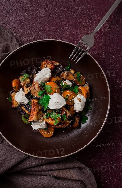 Warm Salad with crispy eggplant and tomatoes, cottage cheese, spices, herbs, sesame seeds, sunflower seeds, Georgian cuisine, no people