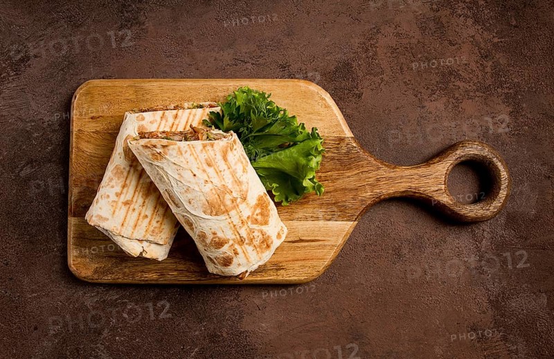 Cut shawarma, 2 pieces, on a cutting board, close-up