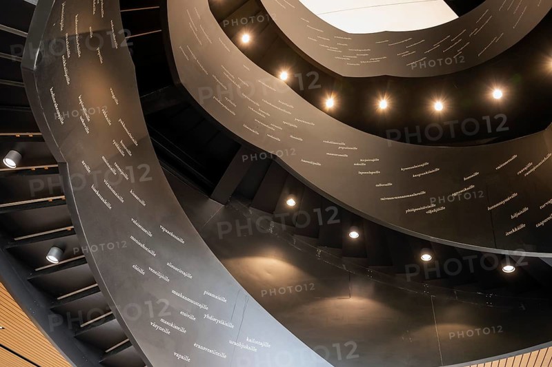 Spiral staircase printed with Finnish words, Oodi Central Library and Cultural Centre, designed by ALA Architects, Helsinki, Finland, Europe