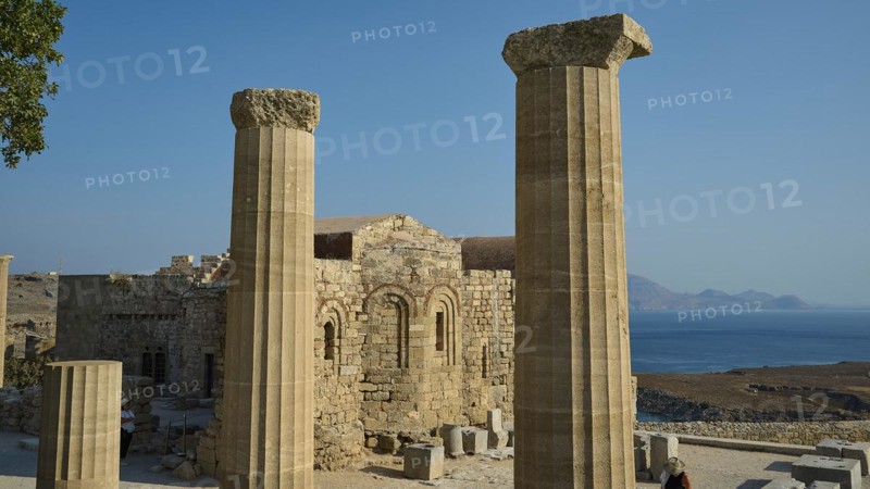 Ruins of an ancient site with columns and a view of the sea under a clear blue sky, Acropolis of Lindos, morning light, Chapel of St John, Lindos, Rhodes, Dodecanese, Greek Islands, Greece, Europe
