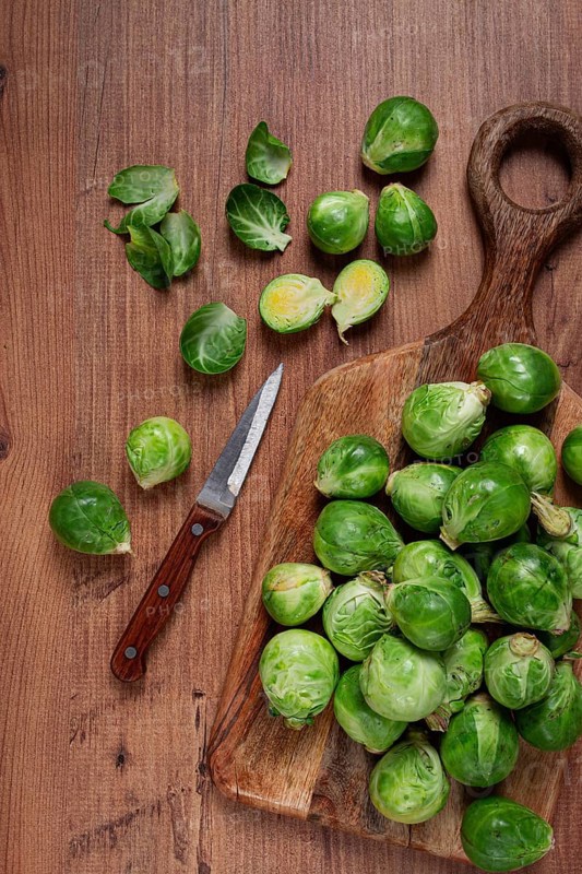 Fresh Brussels sprouts, raw, top view, on a wooden table, no people