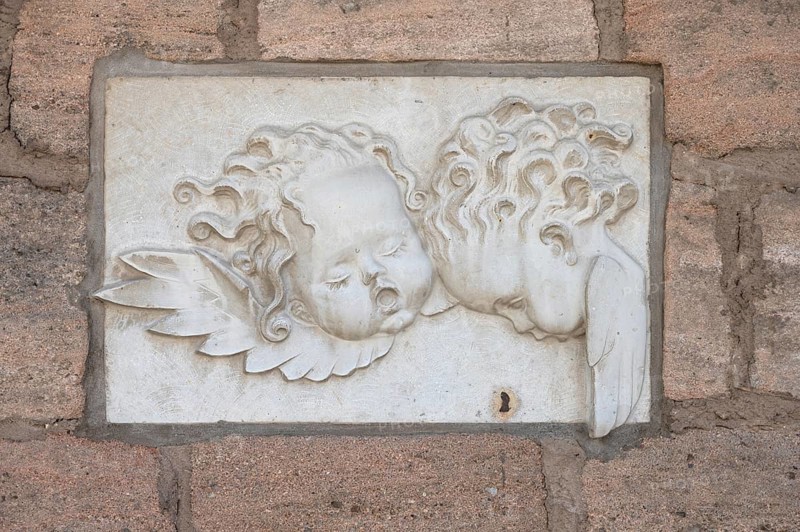 Relief of angel heads on the town wall of the kindergarten, Allersberg, Middle Franconia, Bavaria, Germany, Europe