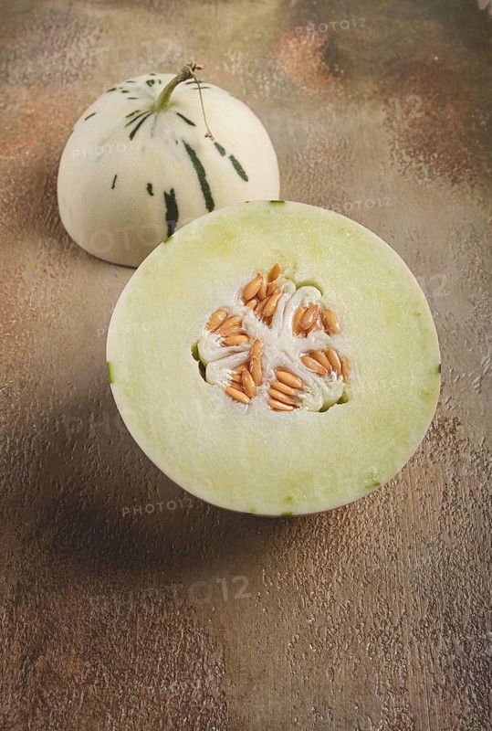 Dino melon, cut, on the table, top view, no people, Dino melon, cut, on the table, top view, no people, white melon with green stripes, dino variety