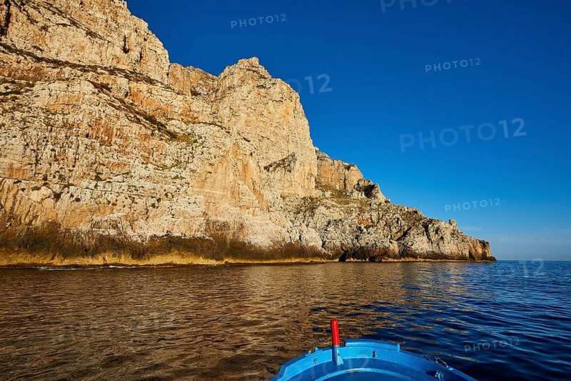 Evening light, boat tour, boat bow, view from the sea, bizarre rock formations, rugged mountains, Marettimo, Egadi Islands, Sicily, Italy, Europe