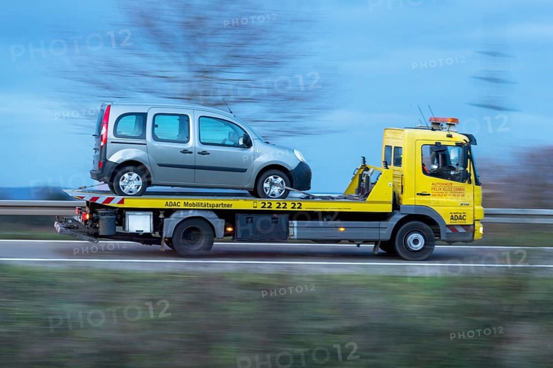 ADAC car transporter with loaded car driving on a country road, twilight, motion blur, Baden-Württemberg, Germany, Europe