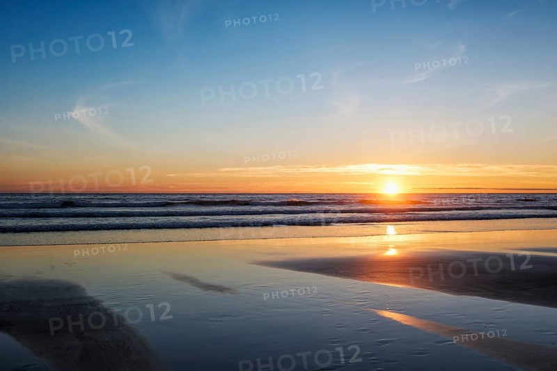 Atlantic ocean sunset with surging waves at Fonte da Telha beach, Costa da Caparica, Portugal, Europe