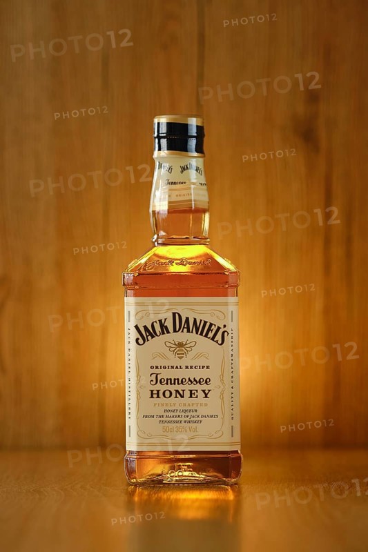 2021, 23 February, Minsk, Belarus, glowing Bottle of Jack Daniel's honey on wooden background (soft focus photo), Europe