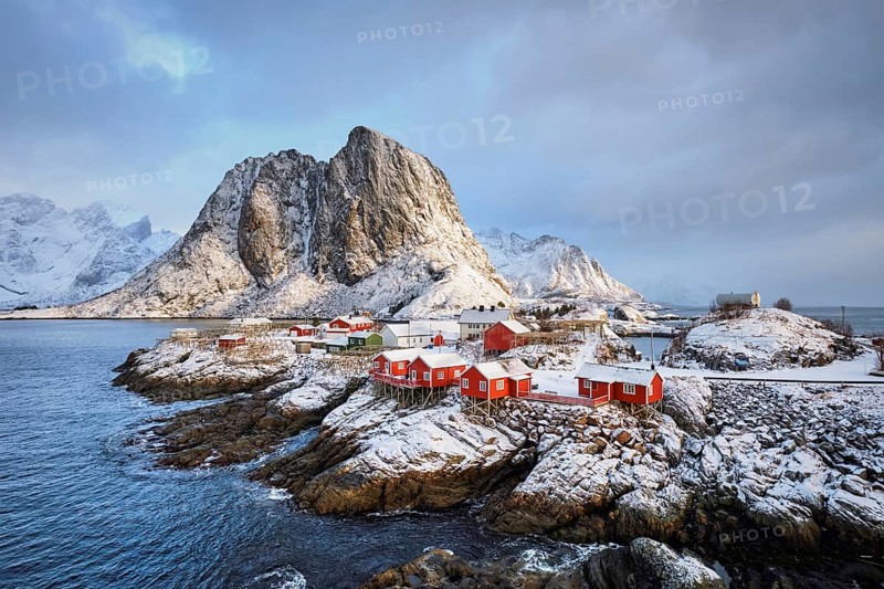 Famous tourist attraction Hamnoy fishing village on Lofoten Islands, Norway with red rorbu houses in winter