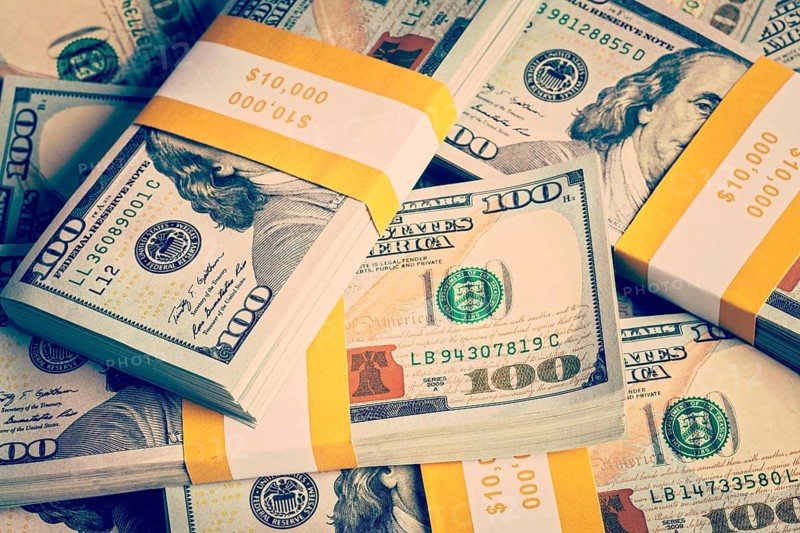 Creative business finance making money concept. Vintage retro effect filtered hipster style image of background of of new 100 US dollars 2013 edition banknotes (bills) bundles close up