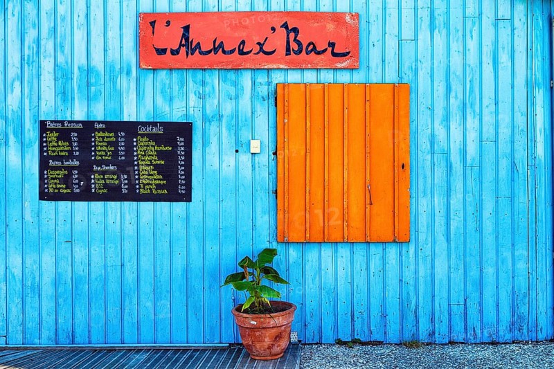 Colourful hut, wooden facade of a bar with orange closed shutter and menu, advertising alcoholic beverages, Le Château-d'Oléron, Oleron Island, Charente Maritime Department, Nouvelle-Aquitaine, France, Europe